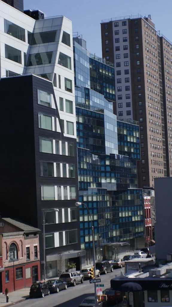 10-story modern apartments: angular buildings with slick glass windows. no human life is visible.